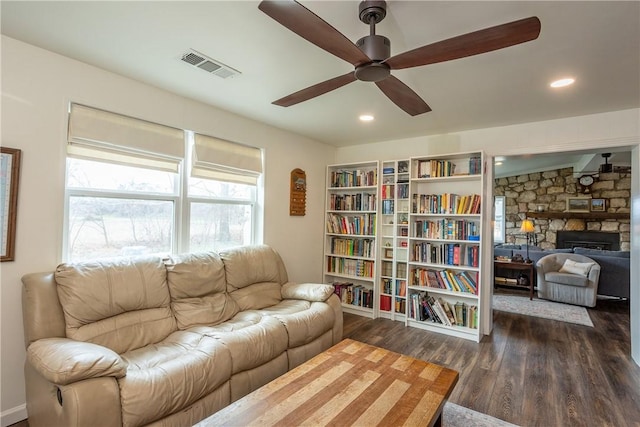 living area with a fireplace, recessed lighting, visible vents, dark wood-type flooring, and ceiling fan