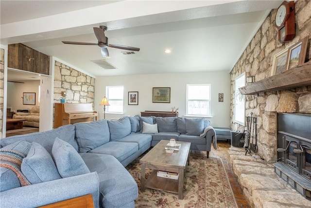 living room with a ceiling fan and visible vents