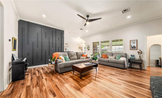 living room with light wood-type flooring, ceiling fan, and ornamental molding