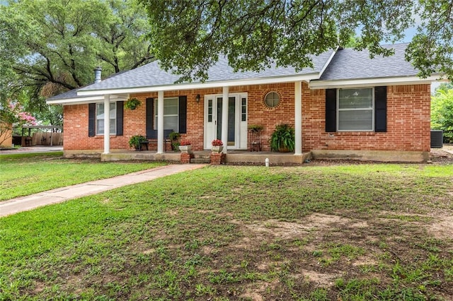 ranch-style home featuring central AC, a porch, and a front yard