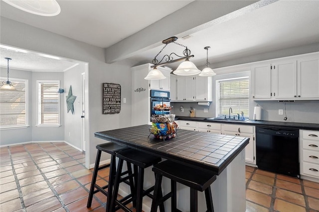 kitchen featuring black appliances, a kitchen breakfast bar, white cabinets, sink, and tile counters