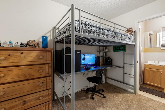 carpeted bedroom with sink and a textured ceiling