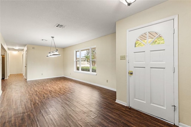 entryway featuring a textured ceiling and dark hardwood / wood-style flooring