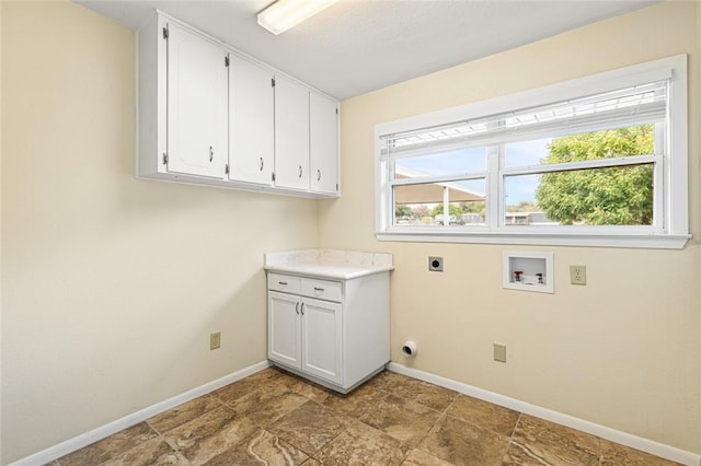 washroom with hookup for an electric dryer, hookup for a washing machine, cabinets, and a healthy amount of sunlight