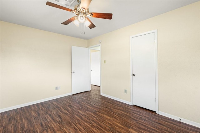 unfurnished bedroom with ceiling fan and dark wood-type flooring