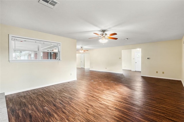 spare room with dark hardwood / wood-style flooring and ceiling fan