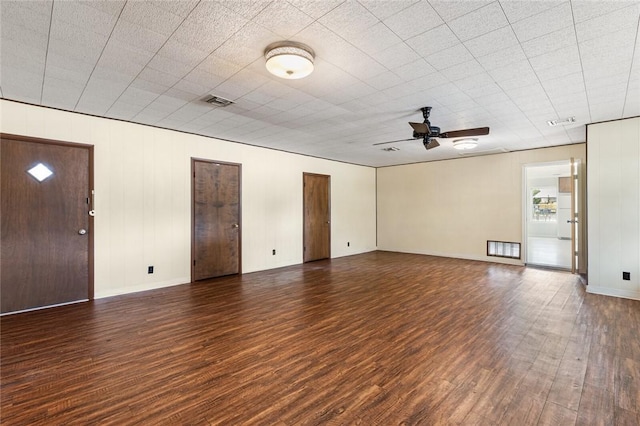 unfurnished living room featuring dark hardwood / wood-style floors and ceiling fan