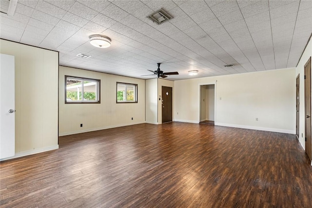 empty room with ceiling fan and dark wood-type flooring