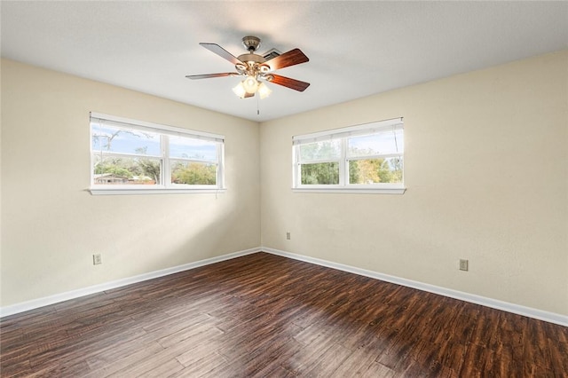 unfurnished room with ceiling fan and dark hardwood / wood-style flooring