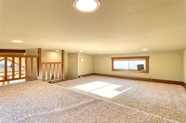 carpeted empty room with a textured ceiling