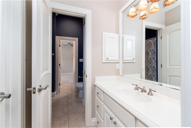 bathroom featuring tile patterned flooring, vanity, toilet, and walk in shower