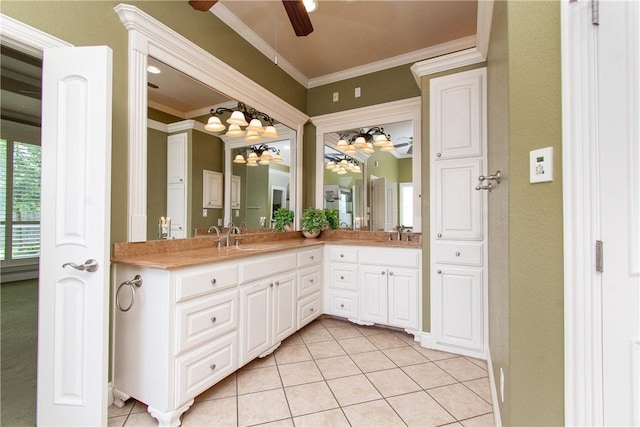 bathroom with tile patterned floors, crown molding, and vanity