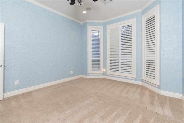 unfurnished room with ceiling fan, carpet floors, and crown molding