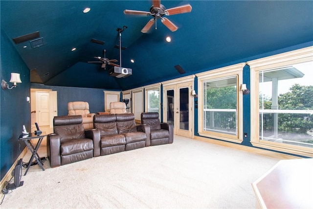 carpeted cinema room featuring a wealth of natural light, french doors, ceiling fan, and lofted ceiling