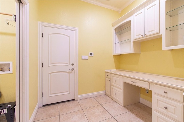 washroom with washer hookup, light tile patterned floors, cabinets, and ornamental molding