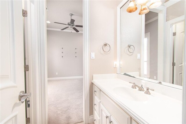 bathroom featuring ceiling fan, vanity, and ornamental molding