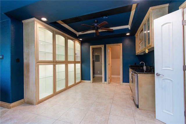 kitchen featuring ceiling fan, a raised ceiling, stainless steel dishwasher, dark stone counters, and light tile patterned flooring