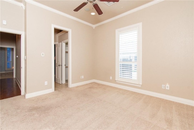 carpeted empty room featuring crown molding and ceiling fan