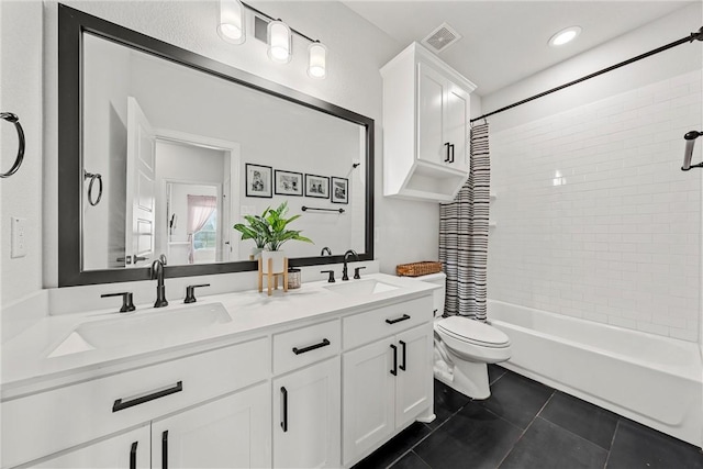 full bath with toilet, shower / bath combo, a sink, and tile patterned floors