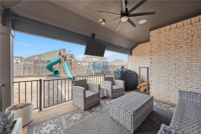 view of patio with ceiling fan, a playground, a fenced backyard, grilling area, and a trampoline