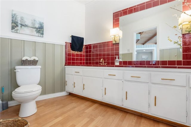 full bathroom with decorative backsplash, vanity, toilet, and wood finished floors