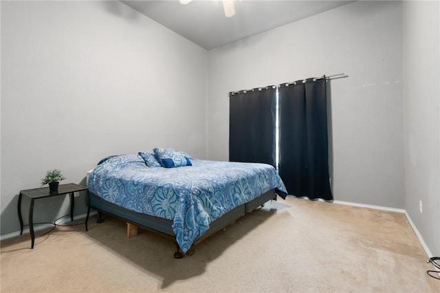 carpeted bedroom featuring baseboards and a ceiling fan