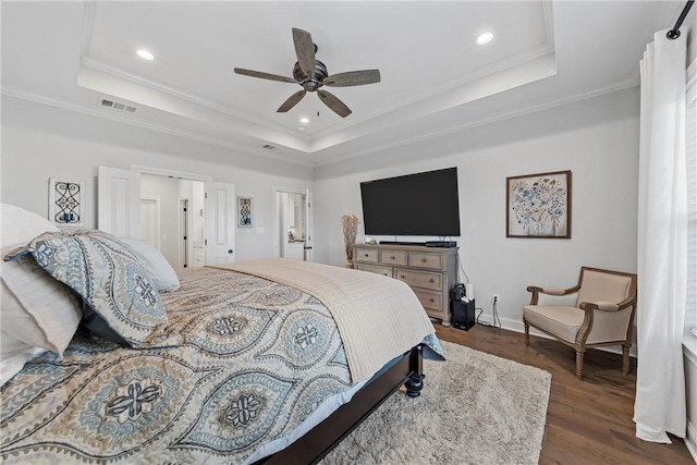 bedroom featuring visible vents, a raised ceiling, and dark wood-style flooring