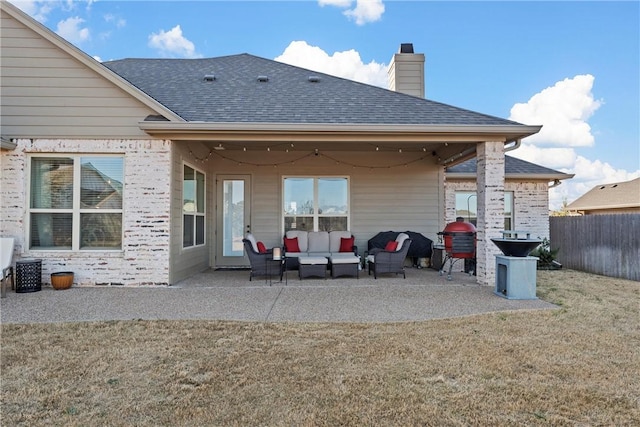 rear view of house featuring an outdoor hangout area, a shingled roof, a patio, and fence