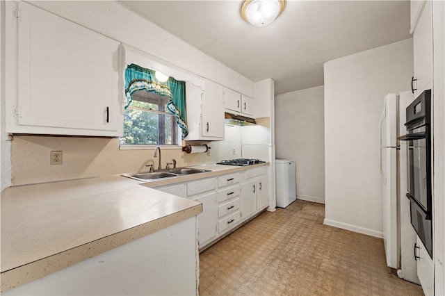 kitchen featuring sink, white cabinets, black double oven, and stainless steel gas stovetop