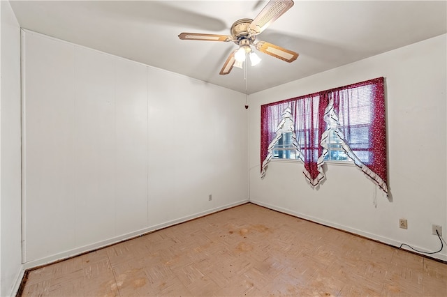 unfurnished room with light parquet floors and ceiling fan