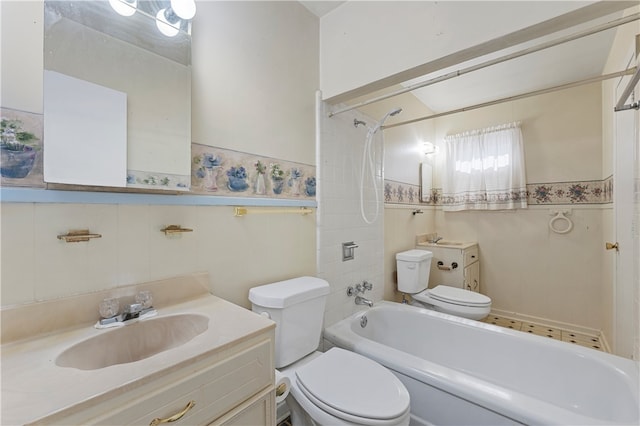 full bathroom featuring tiled shower / bath, vanity, toilet, and tile walls