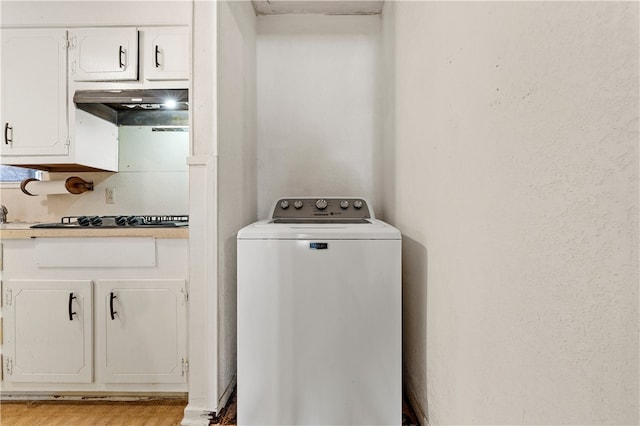 laundry area featuring light hardwood / wood-style floors and washer / clothes dryer