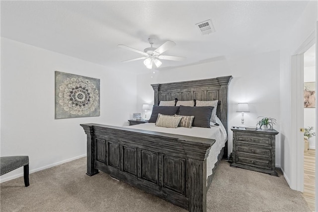 bedroom with visible vents, light carpet, baseboards, and ceiling fan