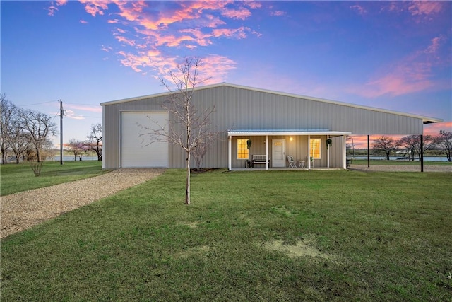 exterior space with a yard, covered porch, and driveway