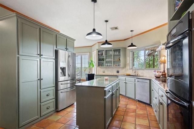 kitchen featuring a center island, backsplash, crown molding, hanging light fixtures, and appliances with stainless steel finishes