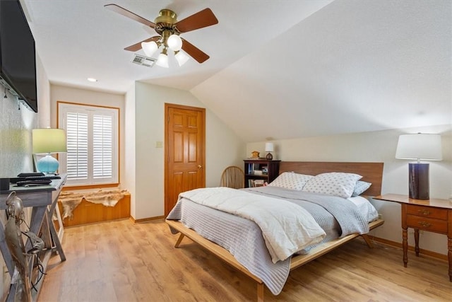 bedroom featuring light hardwood / wood-style flooring, ceiling fan, and lofted ceiling