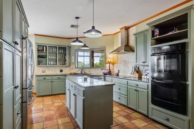 kitchen featuring wall chimney range hood, pendant lighting, decorative backsplash, a kitchen island, and black appliances