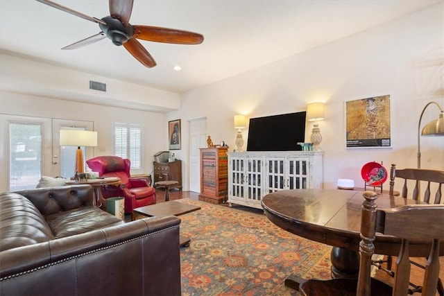 living room featuring ceiling fan and french doors