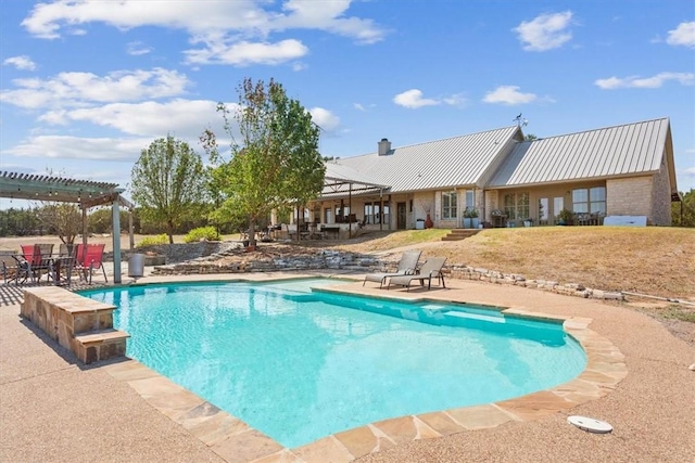 view of pool with a pergola and a patio