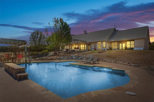 pool at dusk featuring a pergola and a patio area