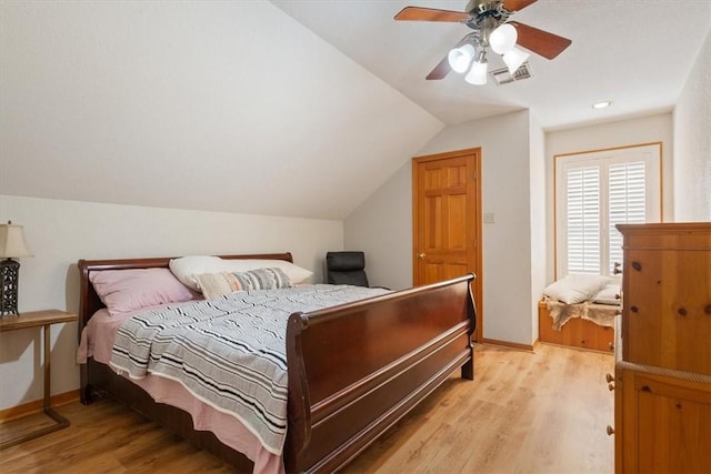 bedroom with light hardwood / wood-style flooring, ceiling fan, and lofted ceiling