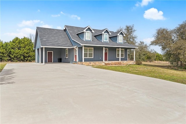 view of front of home with a front yard and driveway