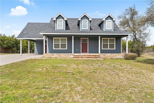 cape cod house with board and batten siding, a front lawn, covered porch, and driveway