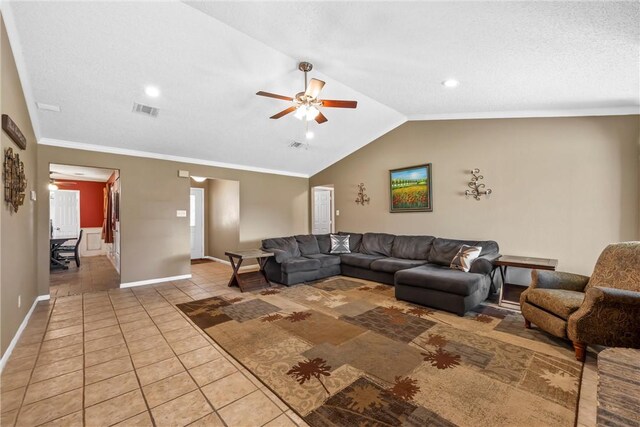 living area featuring light tile patterned floors, visible vents, lofted ceiling, ornamental molding, and ceiling fan