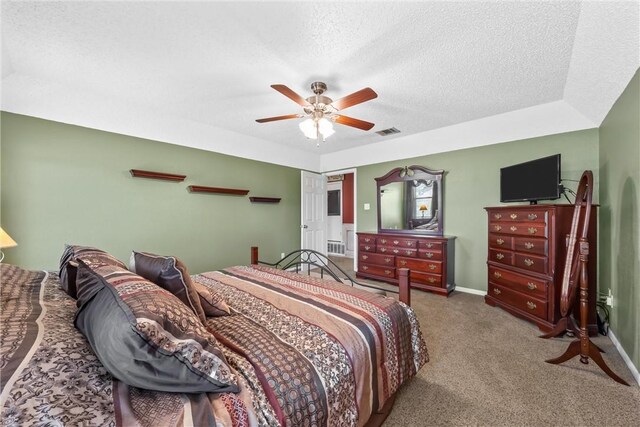 bedroom featuring baseboards, carpet flooring, a textured ceiling, and visible vents