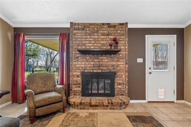 tiled living area featuring a fireplace, a textured ceiling, crown molding, and baseboards