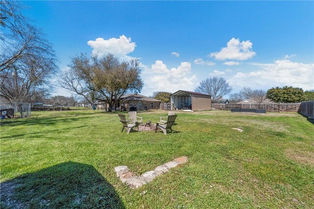 view of yard featuring fence and an outdoor fire pit