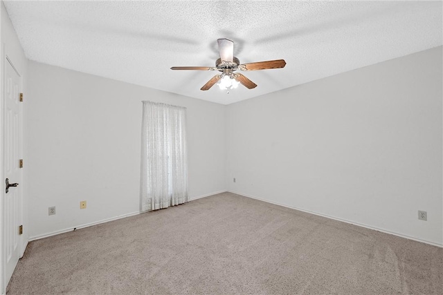 unfurnished room featuring light carpet, ceiling fan, and a textured ceiling