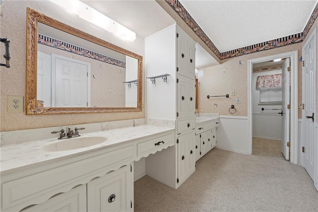 bathroom featuring a textured ceiling and vanity