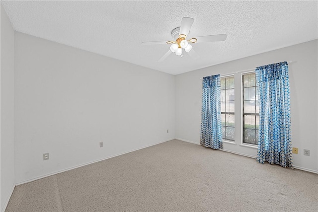 empty room with ceiling fan, a textured ceiling, and carpet flooring